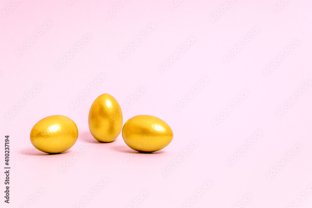 Three Easter eggs decorated with gold paint on a pink background. Concept for Easter, spring. Selective focus. Copy space. Three Easter eggs decorated with gold paint on a pink background. Concept for Easter, spring. Selective focus. Copy space.