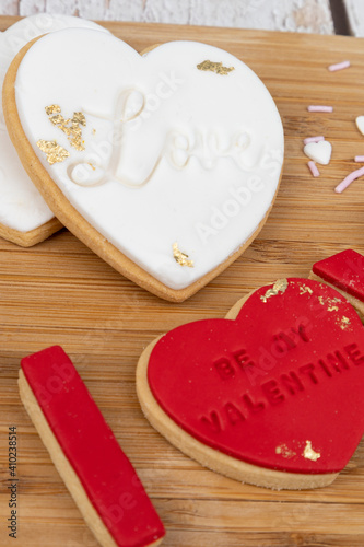 Romantic-themed cookies displayed on a wooden baord photo