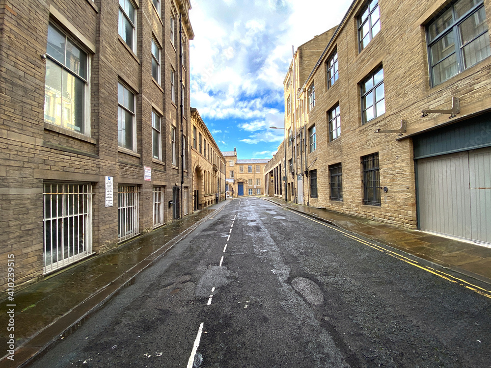 View down, Scoresby Street, lined with stone built Victorian warehouse in, Little Germany, Bradford, UK