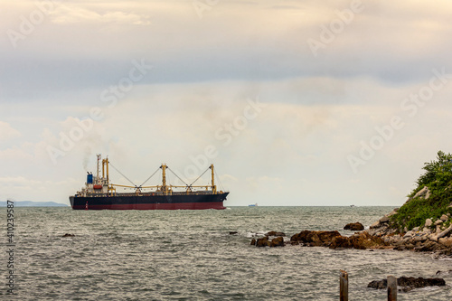 Large cargo ship for transportation import export goods sailed in the middle offshore of the sea in evening © Surasak