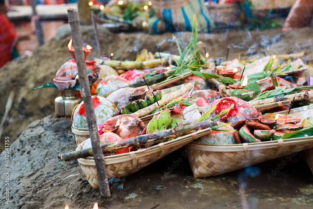 holy offerings of fruits flowers lamps and cloths in river to sun god on the occasion of chhath puja or chatt puja