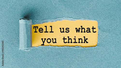 Фотография TELL US WHAT YOU THINK words written under ripped and torn paper.