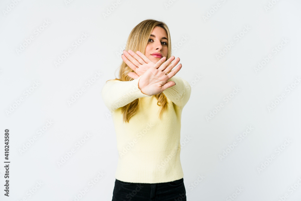 Young caucasian blonde woman doing a denial gesture Young caucasian blonde woman doing a denial gesture