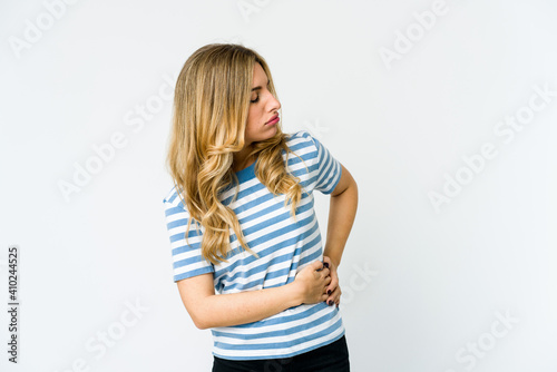 Young caucasian blonde woman having a liver pain, stomach ache.