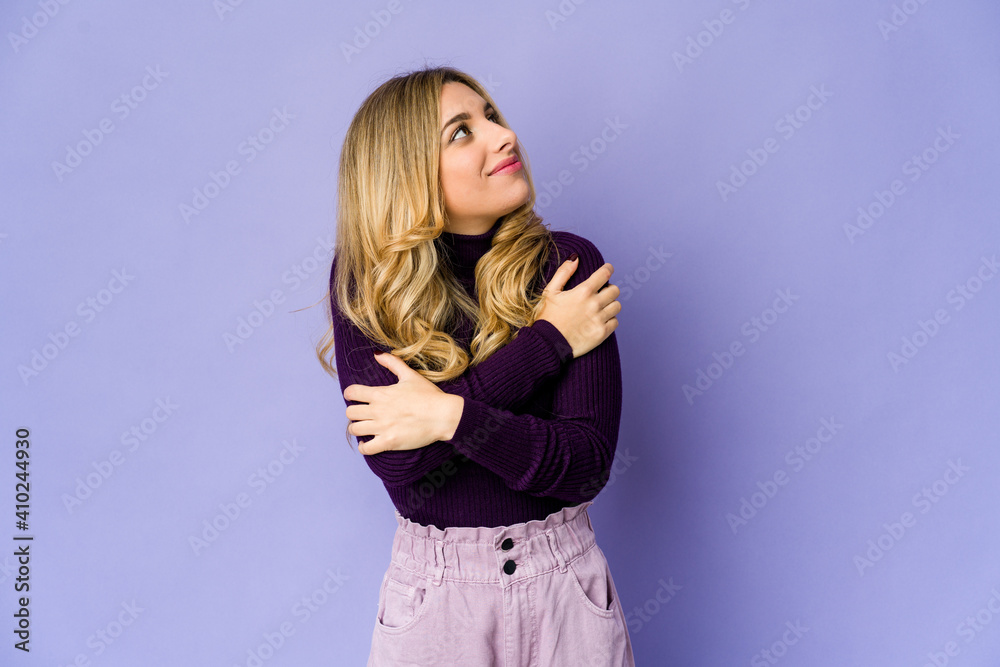 Fototapeta premium Young caucasian blonde woman hugs, smiling carefree and happy.