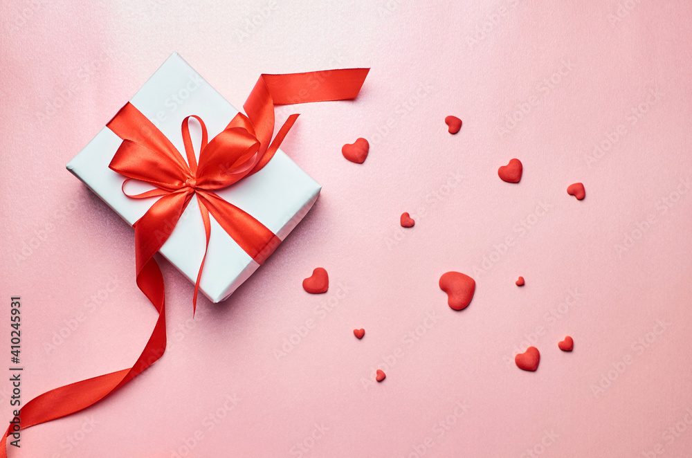 Valentines day gift box with red hearts on pink background Valentines day gift box with red hearts on pink background