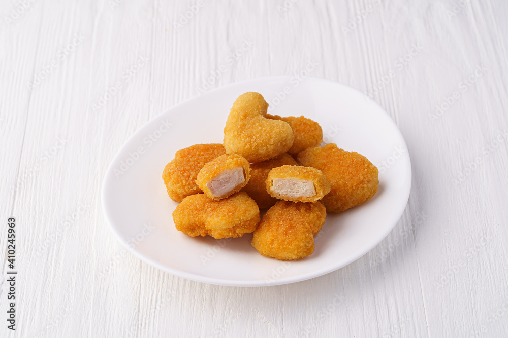 Chicken nuggets on a white plate Chicken nuggets on a white plate