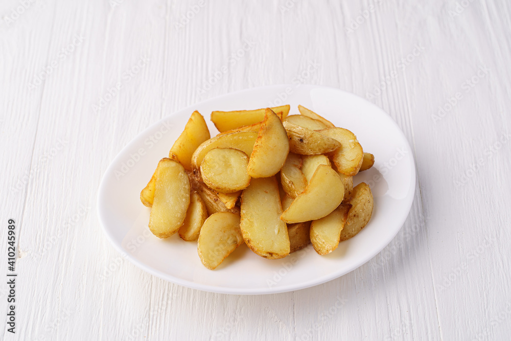 Rustic fried potatoes on a white plate Rustic fried potatoes on a white plate