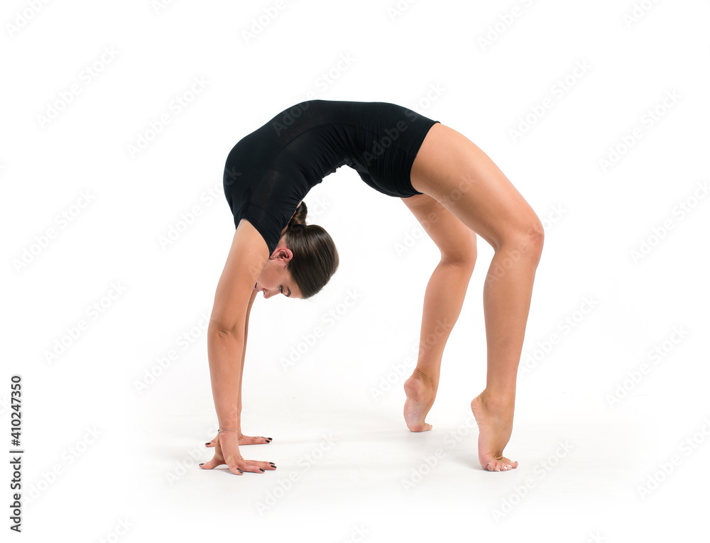Flexibility athletic young woman in sportswear performs gymnastic stretching exercises. Sports motivation and healthy lifestyle