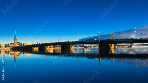 riga. in the photo, the stone bridge, in the background, the city against the blue sky © fotofotofoto