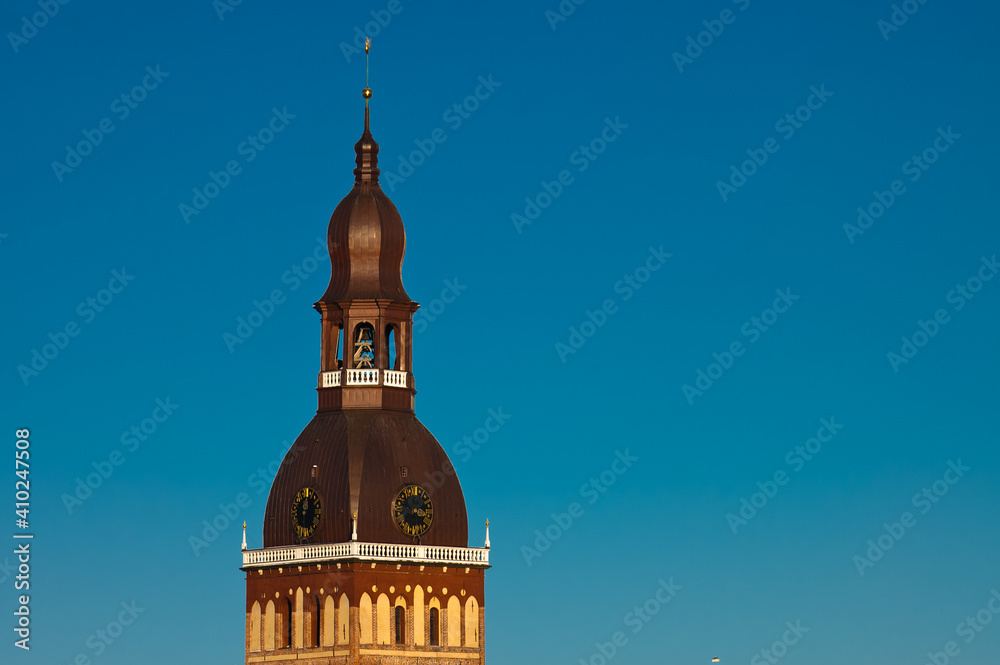 the tower of the dome cathedral against the blue sky the tower of the dome cathedral against the blue sky