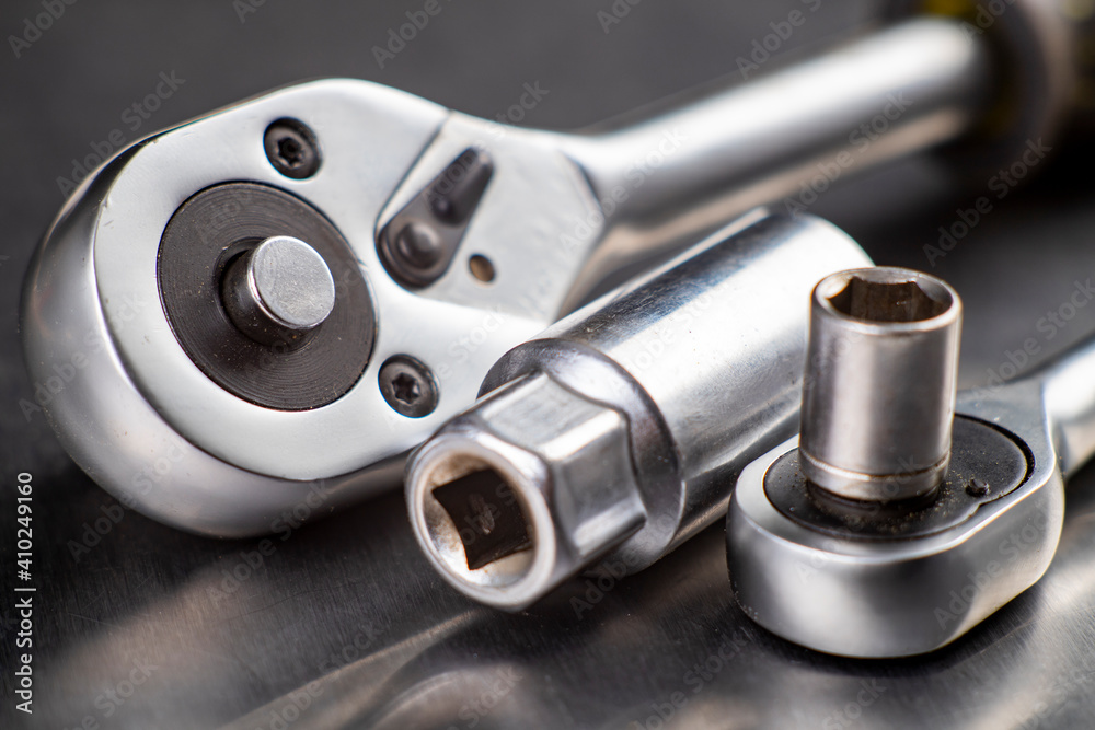 Chrome ratchet wrenches on the workbench. Tools used for mechanical repairs. Chrome ratchet wrenches on the workbench. Tools used for mechanical repairs.