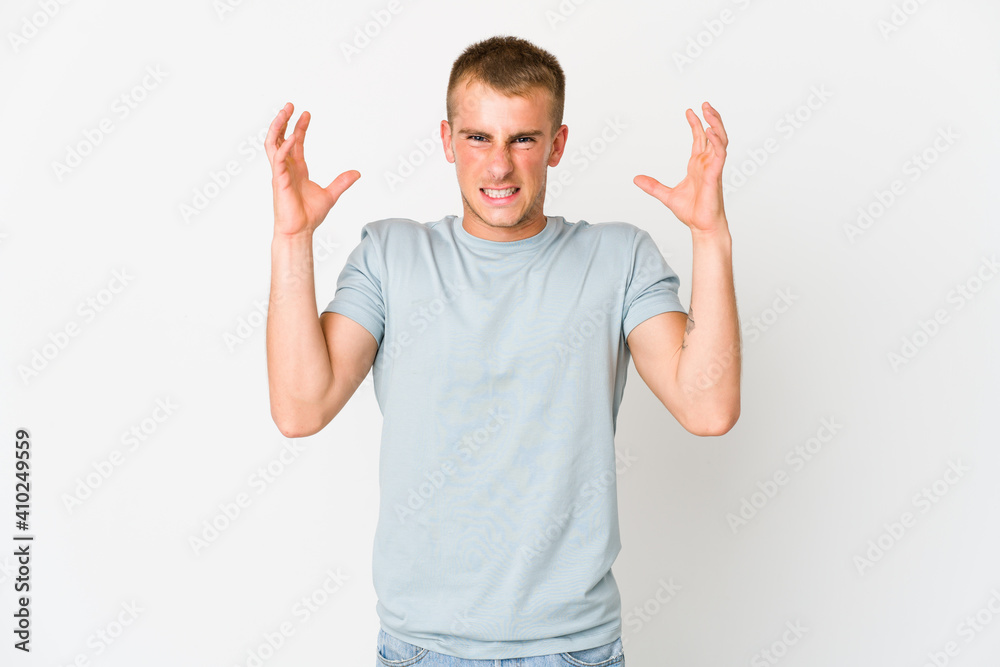 Young caucasian handsome man screaming with rage. Young caucasian handsome man screaming with rage.