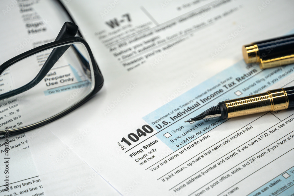 Filling US tax form. Tax form USA business income office concept. Tax Return Form 1040 Filling US tax form. Tax form USA business income office concept. Tax Return Form 1040