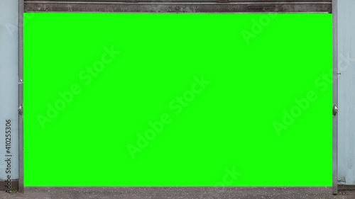 Grungy Urban Metal Store Shutters Opening And Then Closing, With Green Screen Behind
