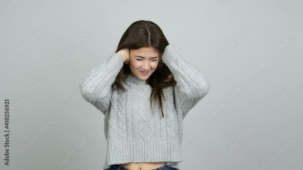 Teenager Brazilian girl covering both ears with hands. Frustrated expression over isolated background Teenager Brazilian girl covering both ears with hands. Frustrated expression over isolated background