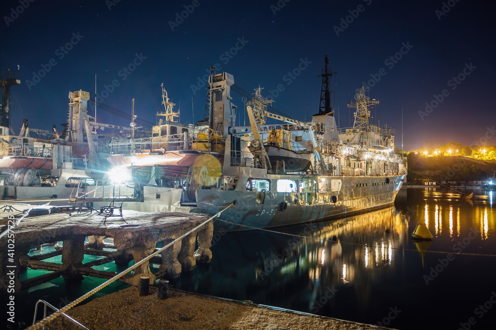 Cargo ship and cranes at night in port of Sevastopol, Crimea