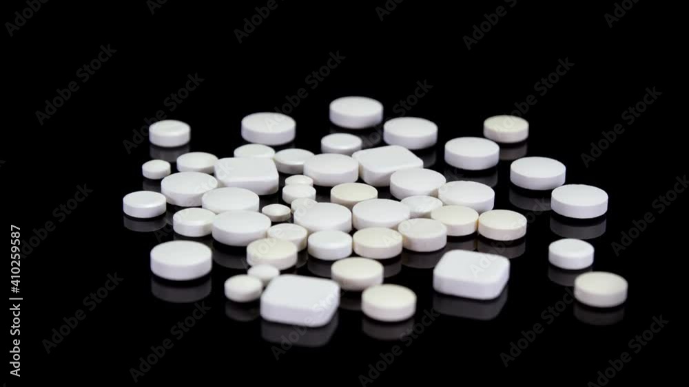 White pills, drugs, supplements, vitamins rotating on a black background. Medical pills rotating in 4K. Concept: Painkillers, doping, opioid crisis, health care, addiction, pharmacy
White pills, drugs, supplements, vitamins rotating on a black background. Medical pills rotating in 4K. Concept: Painkillers, doping, opioid crisis, health care, addiction, pharmacy
