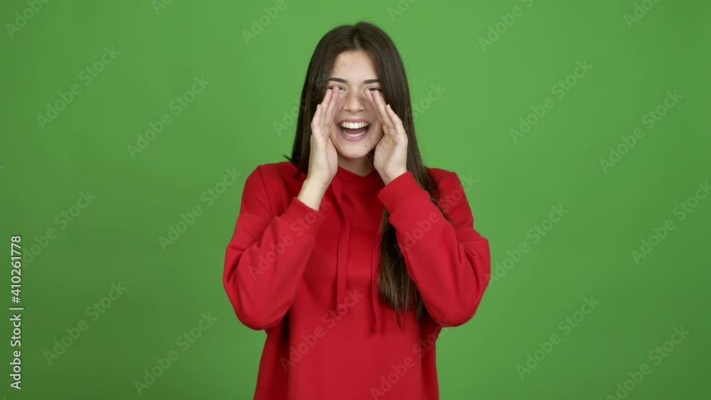 Teenager Brazilian girl shouting and announcing something over isolated background. Green screen chroma key video