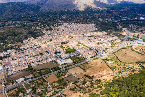 Spain, Balearic Islands, Majorca, Pollena, Town and¬†Tramuntana¬†Mountains, aerial view photo