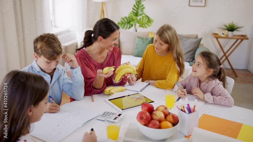 Group of homeschooling children with teacher studying indoors, coronavirus concept.