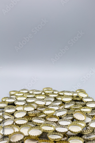 Background with bottle caps of soft drinks and beer with grey background copy space above photo