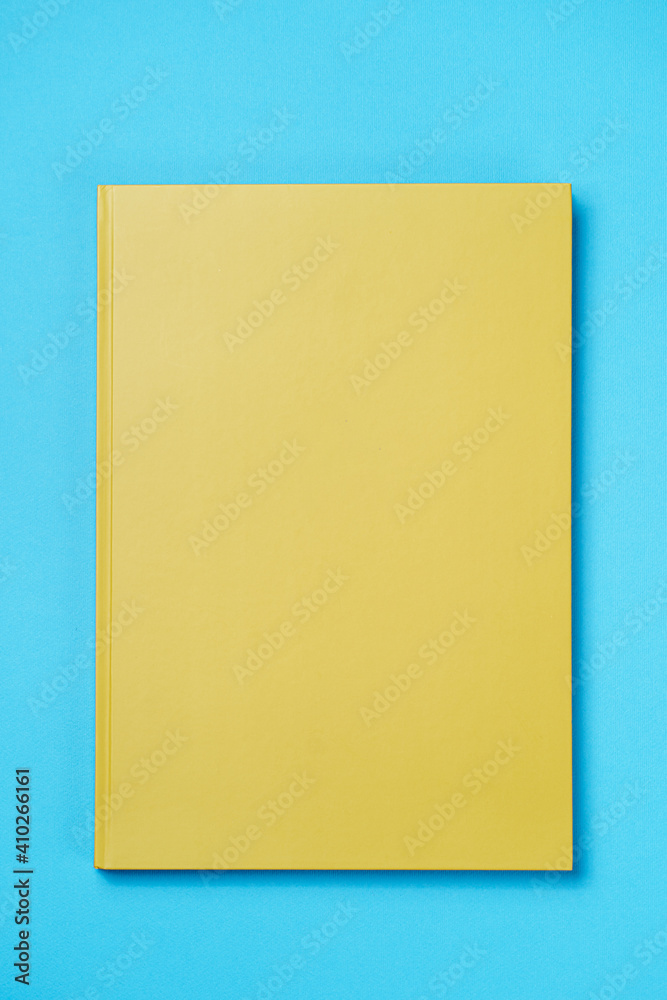 Green Leather notebook on paper blue background, notepad mock up, top view shot - obrazy, fototapety, plakaty 