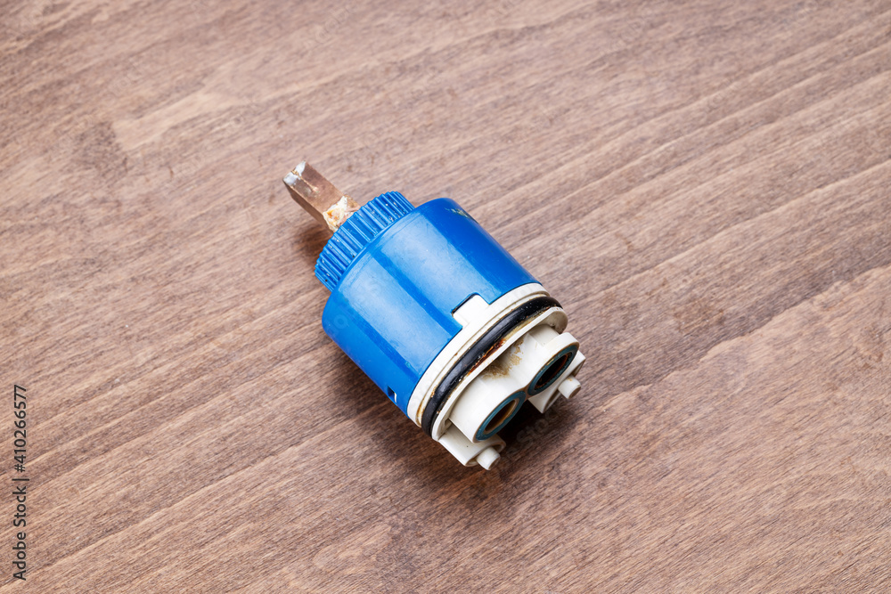old clogged broken faucet cartridge. handyman repair leaky faucet. water tap fix service concept old clogged broken faucet cartridge. handyman repair leaky faucet. water tap fix service concept