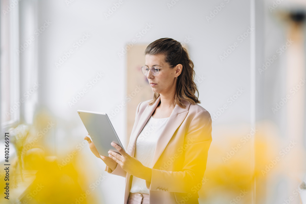 Businesswoman using digital tablet in office Businesswoman using digital tablet in office