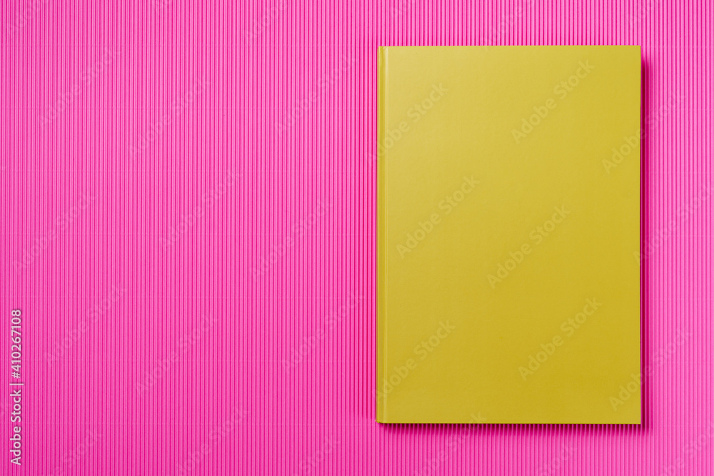 Green Leather notebook on paper pink background, notepad mock up, top view shot Green Leather notebook on paper pink background, notepad mock up, top view shot