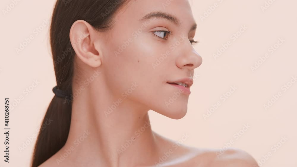 Close-up beauty portrait of young woman with a smooth skin. Woman softly strokes her clavicles | Body care and skin care concept Close-up beauty portrait of young woman with a smooth skin. Woman softly strokes her clavicles | Body care and skin care concept