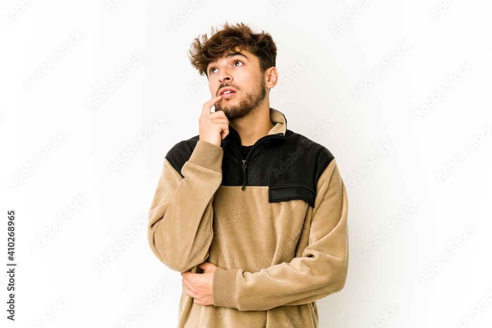 Young arab man on white background looking sideways with doubtful and skeptical expression. Young arab man on white background looking sideways with doubtful and skeptical expression.