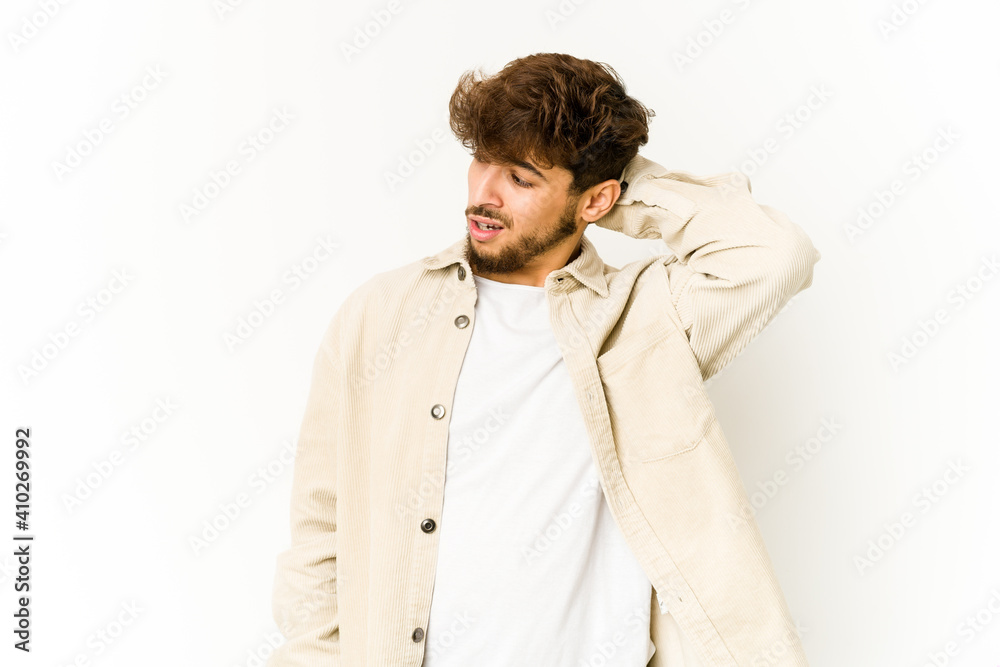 Obraz premium Young arab man on white background tired and very sleepy keeping hand on head.