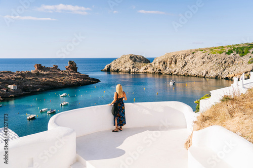 Mature woman looking at sea while standing on terrace against sky photo
