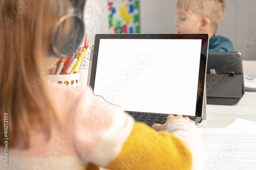 remote education and work, a girl with a laptop with a white screen (space for text)