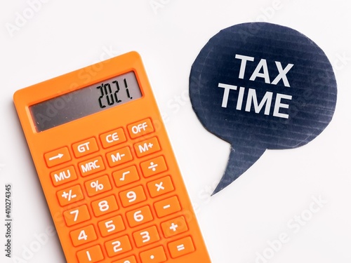 Top view text TAX TIME on bubble speech with calculator. Tax and finance concept. photo