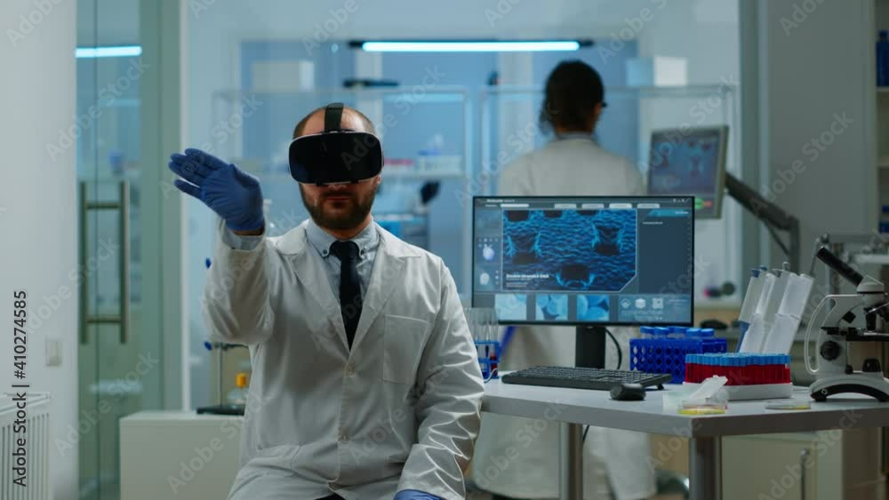 Professional scientist using medical inovation in lab wearing virtual reality glasses, gesticulating. Team of researchers working with equipment device, future, medicine, healthcare, vision, simulator