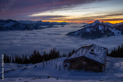 Alps mountain nature landscapes withsnow winter ambiecne after sunset, pre alps mountain bavaria germany foggy mist mountin.