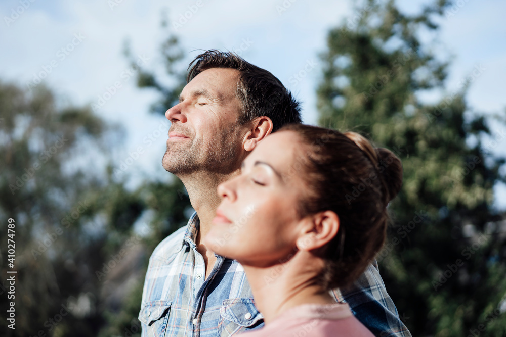 Mature couple with eyes closed on sunny day Mature couple with eyes closed on sunny day