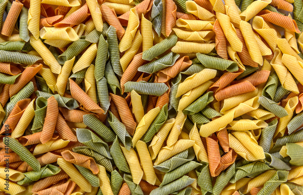 A spread of coloured garganelli past as a background A spread of coloured garganelli past as a background