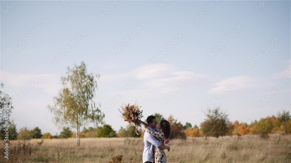 Young Couple Walking on a Meadow. Positive Young Poeple Happieness. Young Couple Walking on a Meadow. Positive Young Poeple Happieness.