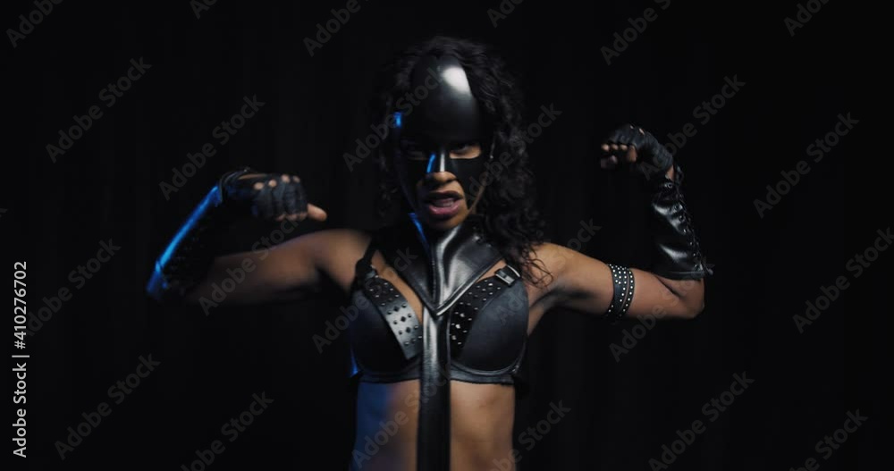 Intimidating superhero, catwoman in leather clothes and a mask is posing, 4k Intimidating superhero, catwoman in leather clothes and a mask is posing, 4k