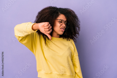 Young african american curly woman isolated on purple background showing thumb down and expressing dislike.