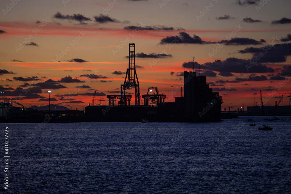 beautiful sunset view of Bilbao harbor with the silhouette of the cranes, Bizkaia, Basque Country, Spain, Europe