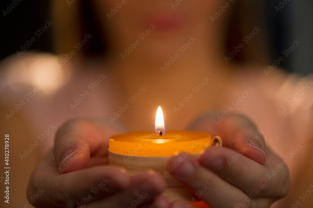 Woman holding tealight Woman holding tealight