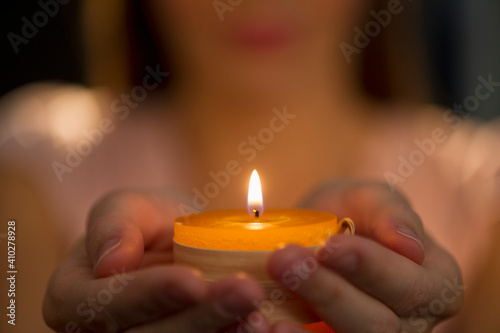 Woman holding tealight photo