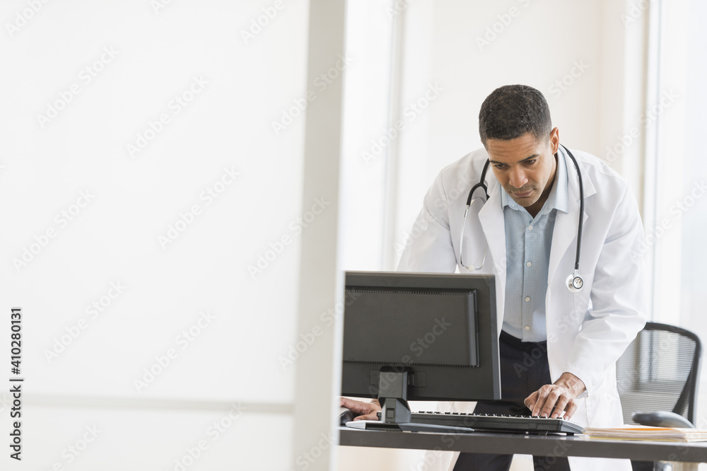 Male doctor using computer in his office Male doctor using computer in his office