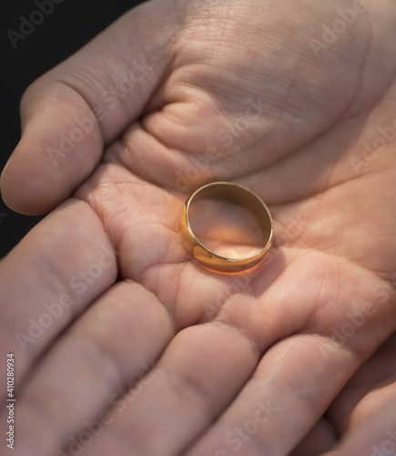 Hand holding wedding ring