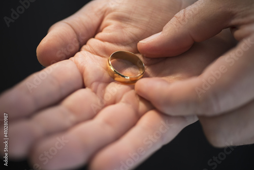 Hand holding wedding ring