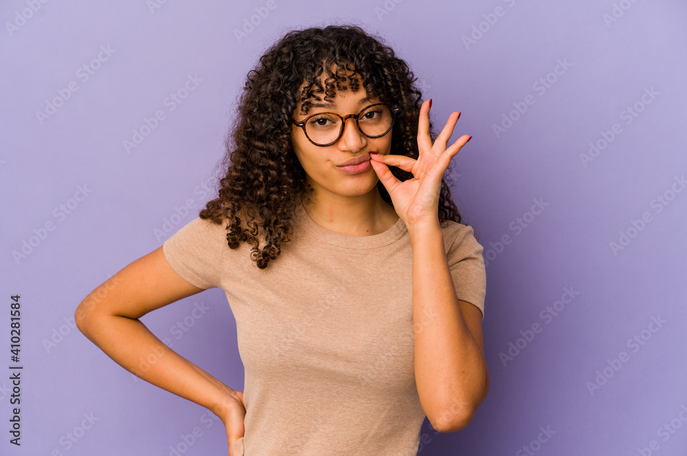 Young african american afro woman isolated with fingers on lips keeping a secret. Young african american afro woman isolated with fingers on lips keeping a secret.